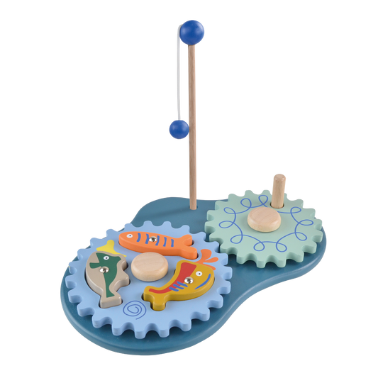 A toy fishing gear set with blue and green gears, a fishing reel, and a few small toy fish on a blue pretend water surface.