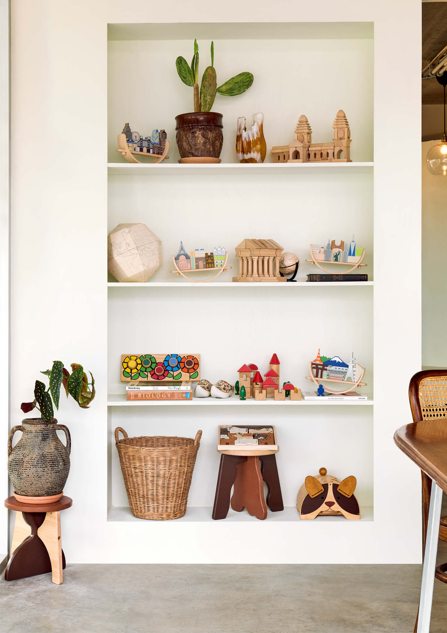 Toys representing New York cityscape arranged on a crescent-shaped base, intended for educational play to promote coordination and social skills.