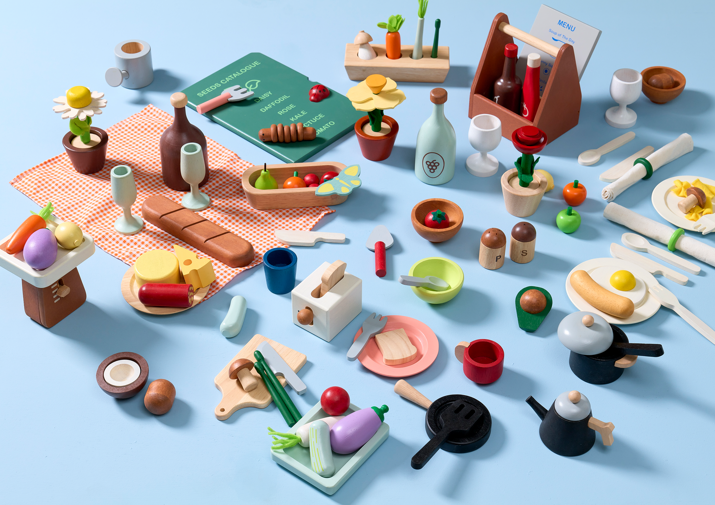 Children's toy farmer's market set with wooden stall and various plastic and wooden food items such as carrots, apples, and mushrooms.