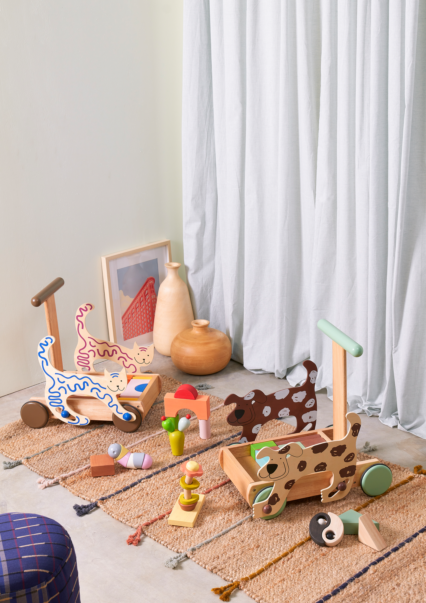 A colorful flower-in-a-pot toy with beads that slide and rattle along twisted wires, designed to stimulate sensory play and encourage grasping and fine motor skills.