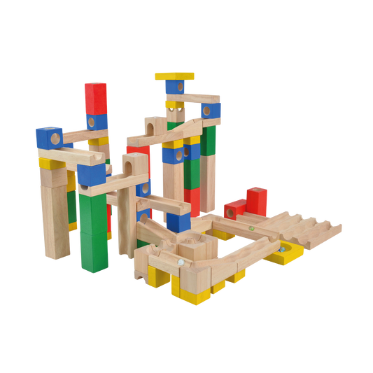 A wooden marble run set with multicolored marbles set up on a track that winds through a series of wooden blocks and tracks on a white background.