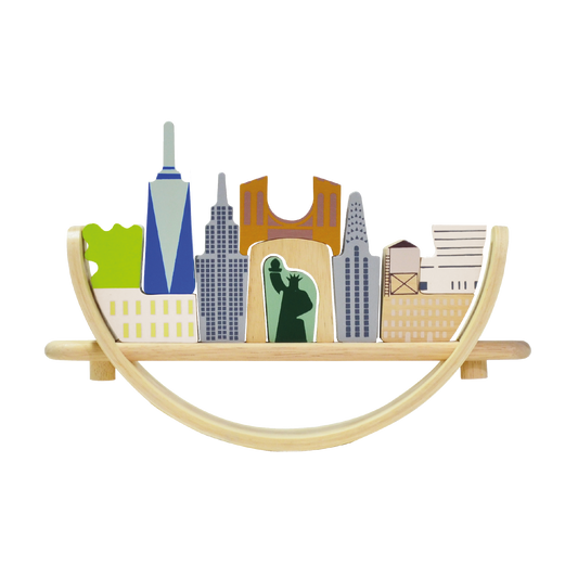 Toys representing New York cityscape arranged on a crescent-shaped base, intended for educational play to promote coordination and social skills.